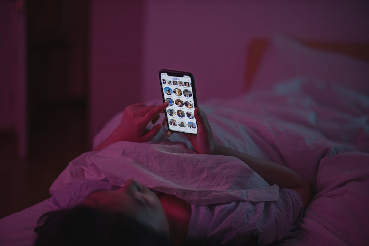 Figure 3. : A woman lying on bed while using smartphone
